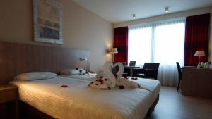 Postel nebo postele na pokoji v ubytování De Keyser Hotel