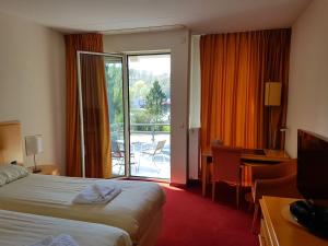 Postel nebo postele na pokoji v ubytování Hotel 2000 Valkenburg