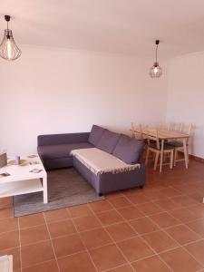 a living room with a couch and a table at Fisherman's House in Aljezur