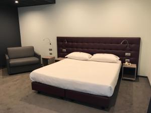Postel nebo postele na pokoji v ubytování Hotel Carnia