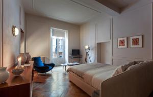 a bedroom with a bed and a desk and a chair at Suites Menaggio in Menaggio