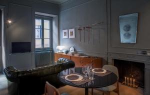 a living room with a table and a couch at Suites Menaggio in Menaggio