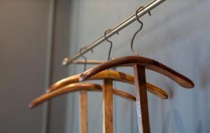 a wooden hanger with a metal pole on it at Suites Menaggio in Menaggio