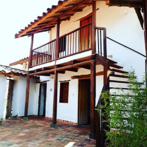 a house with a balcony and stairs on it at la casa de la nona in San Gil