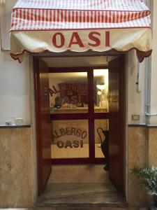 uma porta de vidro de uma loja de sapatos com um sinal em Albergo Oasi em Nápoles