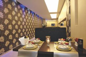 a dining room with a table with plates and silverware at Susuzlu Hotel in İzmir