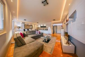 a living room with a couch and a table at Apartments Danigo in Budva
