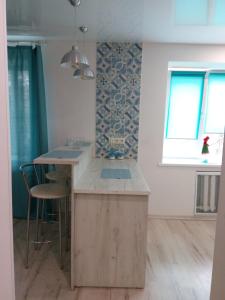 a kitchen with a wooden island in a room at квартира-студия в центре in Khmelnytskyi