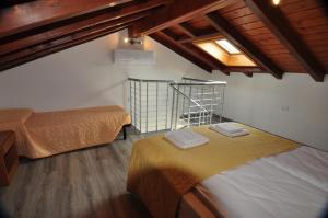 a room with two beds and a ceiling with a window at North Wind Camping & Apartment in Domaso