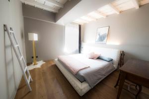 a bedroom with a bed with a ladder and a desk at My Lovely Place Navigli in Milan