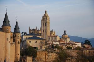 a group of castles on top of a hill at Hotel Infanta Isabel by Recordis Hotels in Segovia