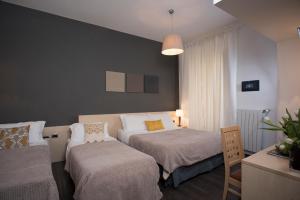 A bed or beds in a room at 111 ColaDiRienzo Rooms - by AD Roma