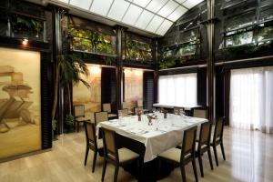 a dining room with a white table and chairs at Crisol Vía Castellana in Madrid