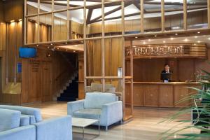 a man standing at a podium in a lobby at Crisol Vía Castellana in Madrid