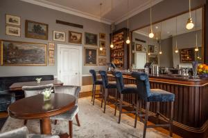 a bar in a pub with chairs and a table at Roseate House London in London