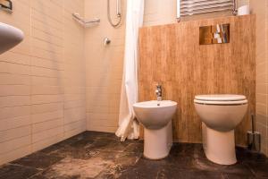 a bathroom with a toilet and a shower at B&B Le Dune - Self Check in in Lascari