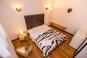 a small bedroom with a bed with a zebra blanket at B&B Le Dune - Self Check in in Lascari