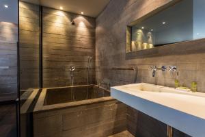 a bathroom with a sink and a tub at CMG - Deluxe Tour Eiffel - 42 in Paris