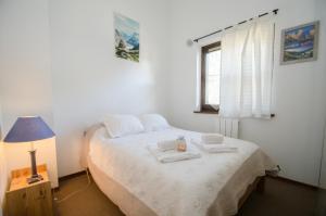 a bedroom with a bed with towels on it at Petra in Chamonix