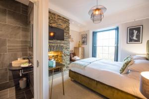 a bedroom with a bed and a stone wall at The Hafod in Devils Bridge