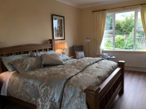 a bedroom with a large bed and a window at Grove House Bed & Breakfast in Carlingford