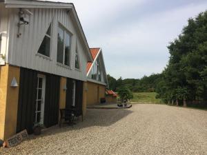 a house with a gravel driveway in front of it at Rainbows End B&B in Sorø