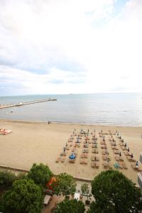 a beach with a bunch of chairs and the ocean at Hotel Edart in Durrës +48 photos