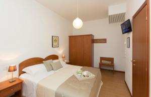 Postel nebo postele na pokoji v ubytování Hotel Giulietta