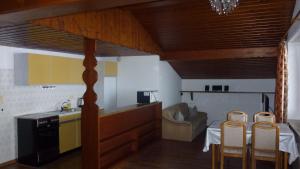 a kitchen with a table and two chairs in a room at Apartement Hasenauer in Fieberbrunn