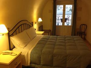 Postel nebo postele na pokoji v ubytování Hotel Relais Modica