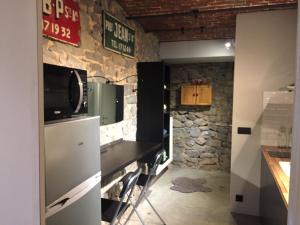 a kitchen with a counter with a tv on a wall at Dailly studio in Dailly