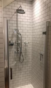 a bathroom with a shower with a shower head at Monmouth House Apartments, Lyme Regis Old Town, dog friendly in Lyme Regis