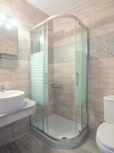 a bathroom with a shower and a sink at Afrodite Beach in Nei Poroi +66 photos