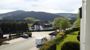 a white truck parked in front of a house at Niedersfeld Polzweg in Winterberg