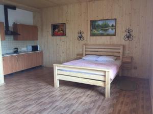 a bedroom with a wooden bed in a room at Софія in Martynkovtsy