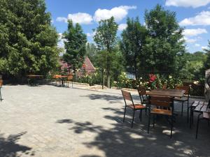 a group of tables and chairs in a park at Софія in Martynkovtsy +6 photos