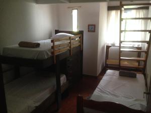 a room with two bunk beds and a window at Zorzal 1 in Puerto Rico