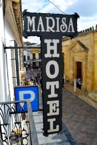 a sign for a store in a street at Hotel Marisa in Córdoba