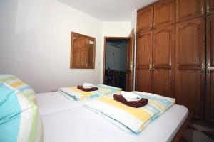 Postel nebo postele na pokoji v ubytování Apartmani Amado/Lozic