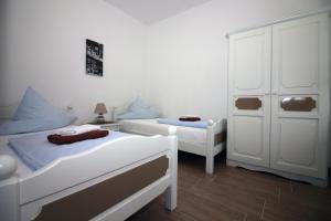 Postel nebo postele na pokoji v ubytování Apartmani Amado/Lozic