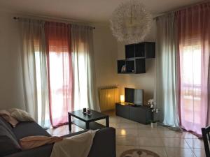 a living room with a couch and a tv at La casa del Professore in Tortora