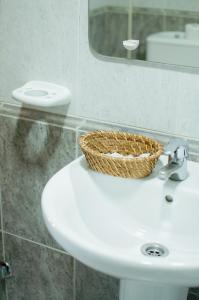 uma cesta sentada em cima de um lavatório na casa de banho em Hostal Concepción em La Mata