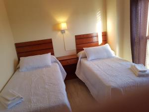 A bed or beds in a room at Apartamentos Olympia Center