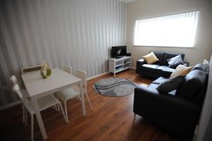 a living room with a table and a couch at Liverpool 2 Bedroom Apartment in Liverpool