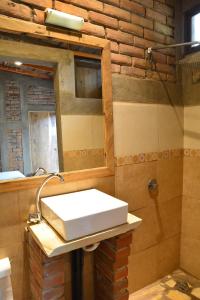 a bathroom with a sink and a mirror at Hostal Casa Abierta in León