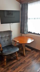 a table and a chair in a room with a window at Bardu Hotell in Sætermoen
