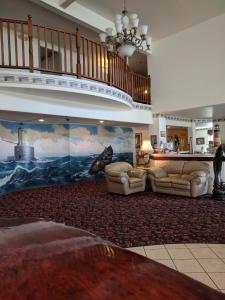 a large living room with two couches and a staircase at Lighthouse Inn in Crescent City