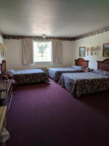 A bed or beds in a room at Lighthouse Inn