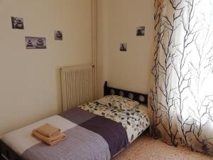 a small bedroom with a bed with a blanket at Sfiggos 54 Guest House in Athens