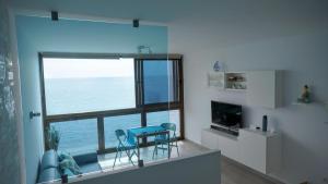 a living room with a view of the ocean at THE BLUE VIEW MASPALOMAS in San Agustin